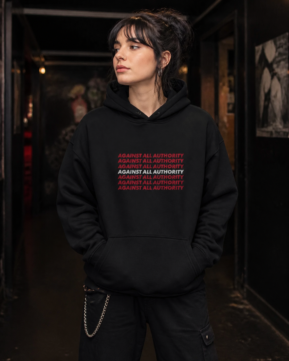 Against All Authority Hoodie in Schwarz an weiblichem Model, Vorderansicht – KI-generierte Darstellung