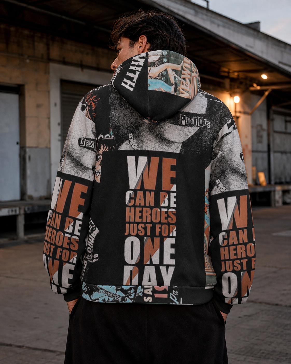 Mann zeigt die Rückseite des Can Heroes Allover Hoodies – KI-generierte Darstellung