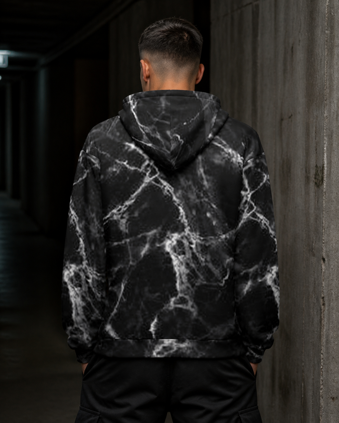 Mann zeigt die Rückseite des Chain Graphic Hoodies mit Alloverprint – KI-generierte Darstellung