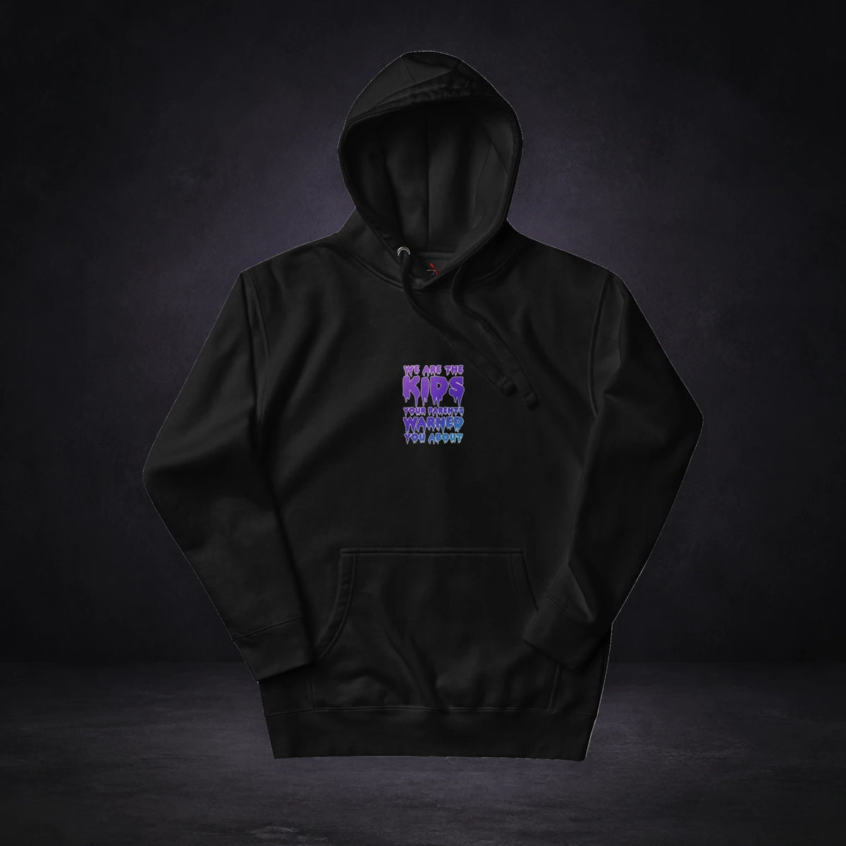 Rich Kids Hoodie von NiZED, Vorderansicht mit Designprint vor dunklem Betonhintergrund