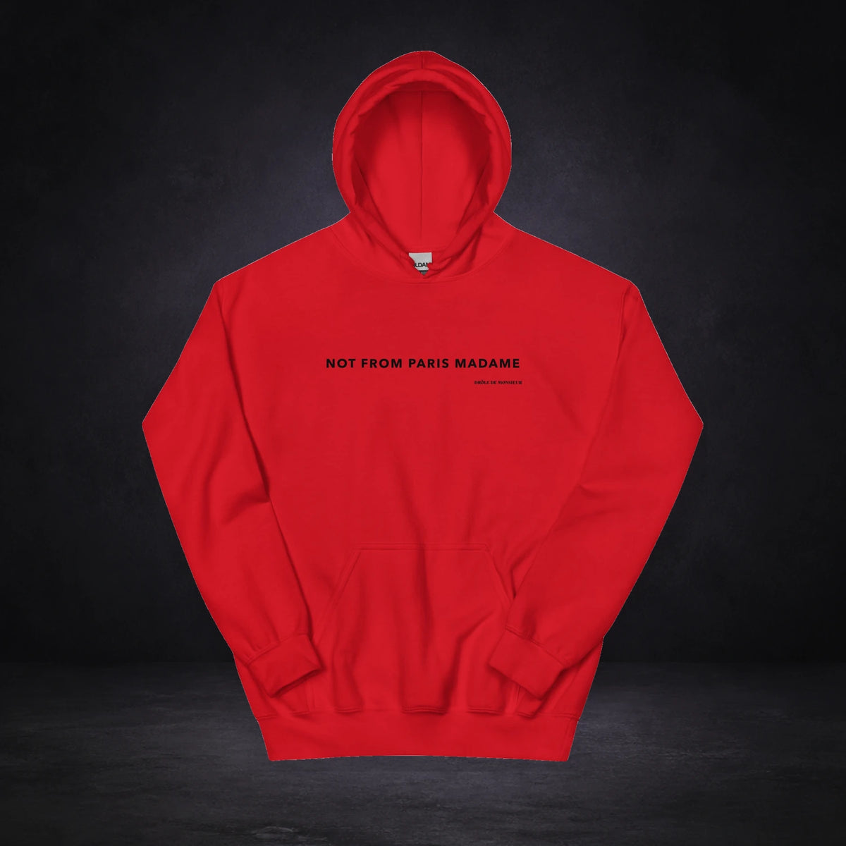 Not From Paris Madam Hoodie von NiZED, Vorderansicht mit Designprint vor dunklem Betonhintergrund