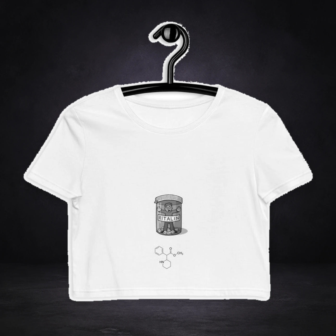 Ritalin Crop Top - Festival Crop Top von NiZED, Vorderansicht mit Designprint vor dunklem Betonhintergrund