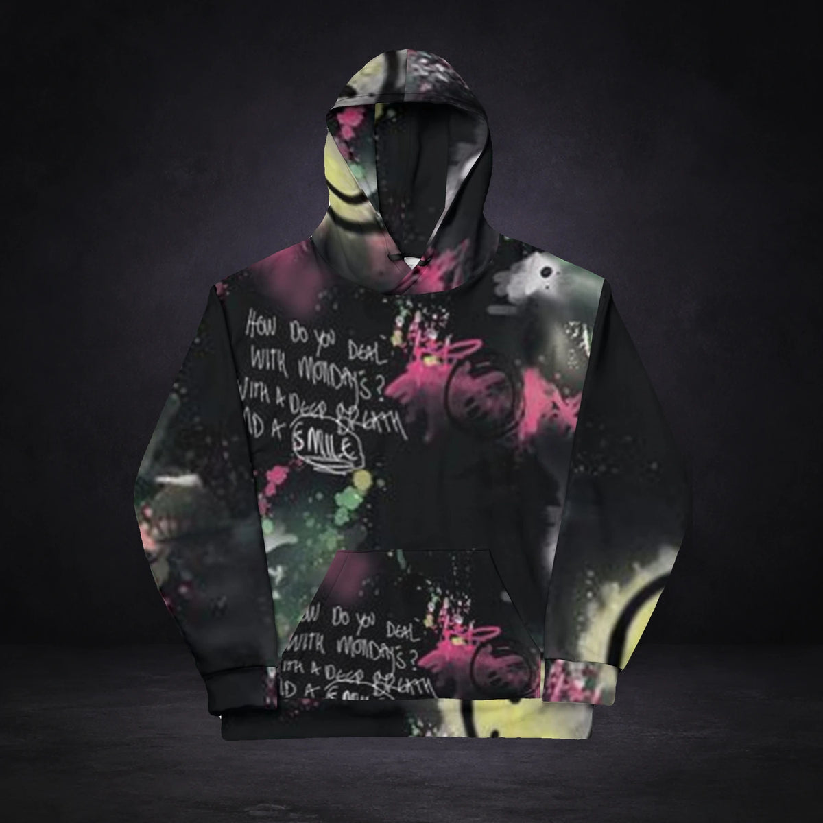 Smile Out Hoodie von NiZED, Vorderansicht mit All-over-Print vor dunklem Betonhintergrund