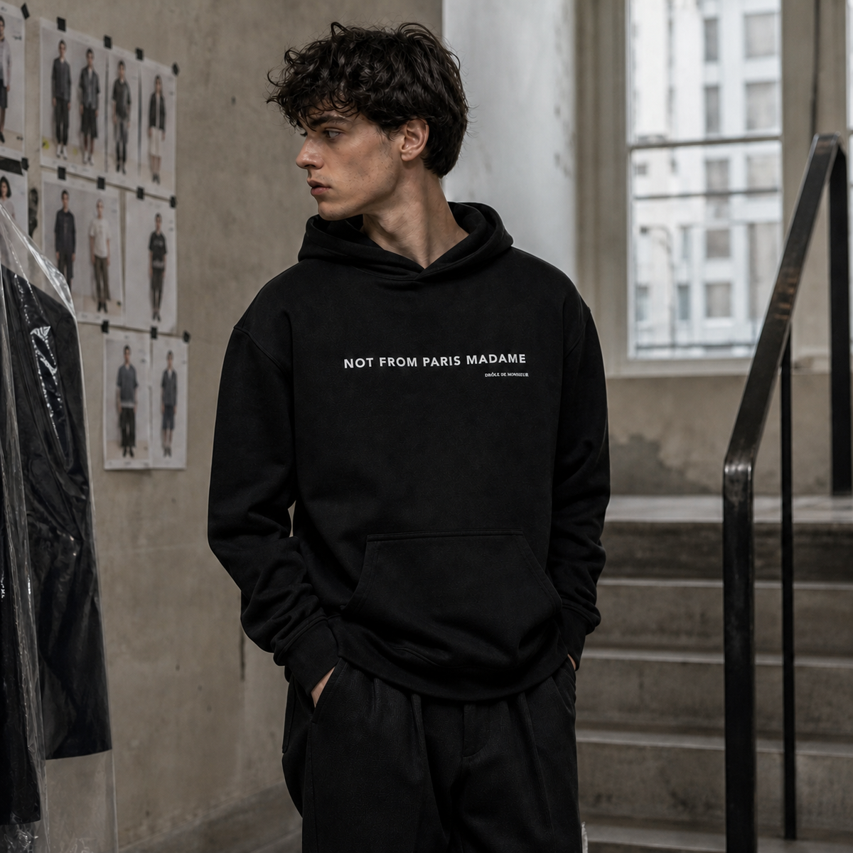 Not From Paris Madam Hoodie am männlichen Model mit Frontprint in einem Berliner Atelier – KI-generierte Darstellung